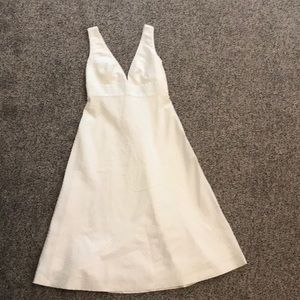 Cream colored dress with plunge neckline.